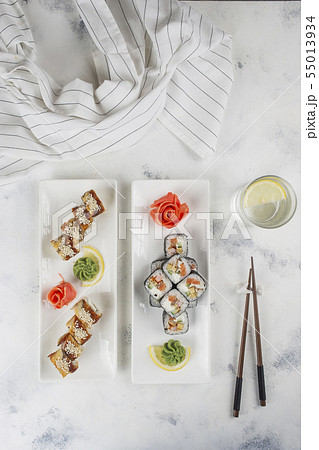 Plates of sushi with chopsticks and drinking glass 55013934