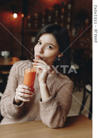 Young woman drinking juice Young woman drinking juice 55014042