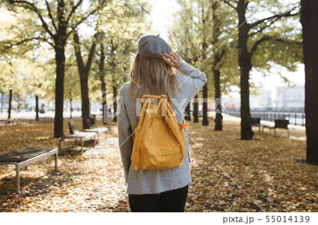 Young woman with yellow backpack in park in Berlin, Germany Young woman with yellow backpack in park in Berlin, Germany 55014139