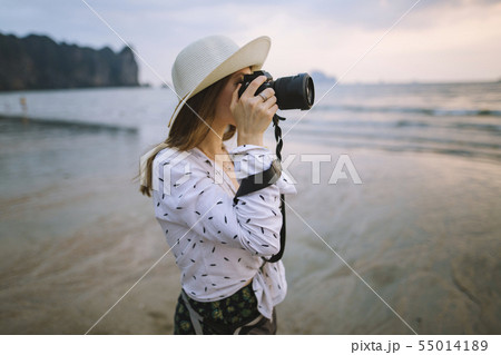 Young woman photographing on beach in Krabi, Thailand 55014189