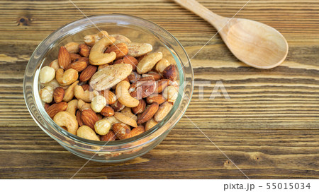 Bake mixed nuts on a wooden table. Bake mixed nuts on a wooden table. 55015034