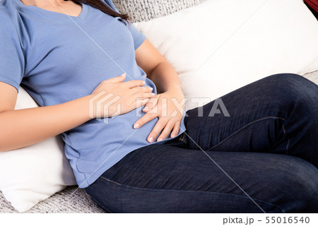 Young woman having painful stomachache Young woman having painful stomachache 55016540