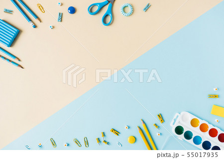 Two-tone background with scattered writing materials. 55017935