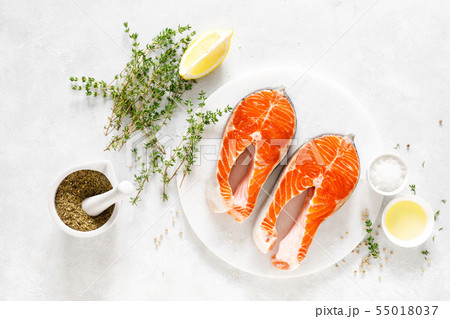 Fresh salmon steaks with ingredients for cooking Fresh salmon steaks with ingredients for cooking 55018037
