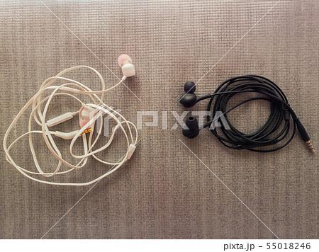 Two pairs of black and white wired headphones, for 55018246