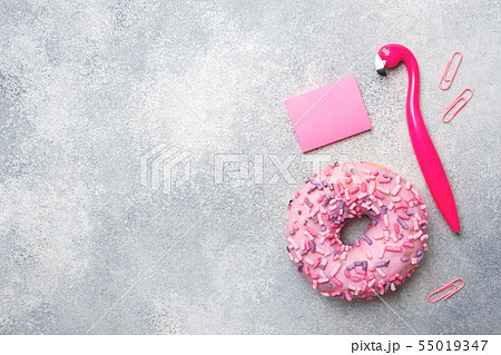 Pink doughnut and Flamingo pen on a grey backgroun Pink doughnut and Flamingo pen on a grey backgroun 55019347
