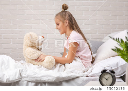 little child girl playing with teddy bear 55020136