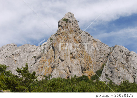 High steep rock cliff against the backdrop of beau High steep rock cliff against the backdrop of beau 55020175
