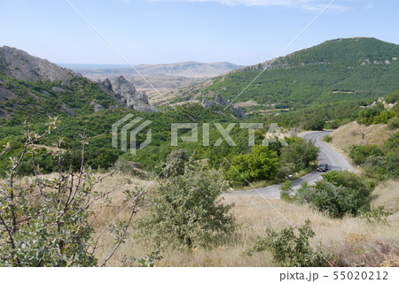 car driving along the highway between the mountain 55020212