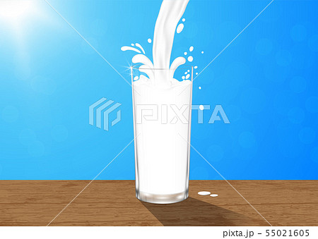 Pouring fresh milk into glass on wooden table 55021605