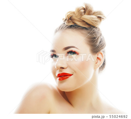 young blond woman with bright make up smiling pointing gesturing emotional isolated like doll lashes 55024692