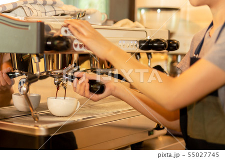 Barista making fresh coffee with machine in coffee shop or cafe. Barista making fresh coffee with machine in coffee shop or cafe. 55027745