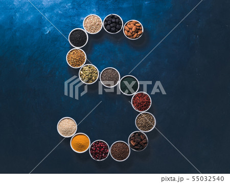 S letter of superfoods in bowl on blue background 55032540