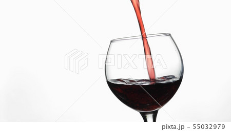 Rose wine. Red wine pour in wine glass over white background 55032979