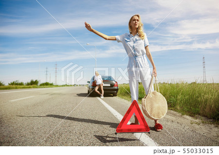 Young lesbian's couple going to vacation trip on the car in sunny day Young lesbian's couple going to vacation trip on the car in sunny day 55033015