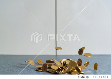 Falling gold coins money on office table with Falling gold coins money on office table with 55034381