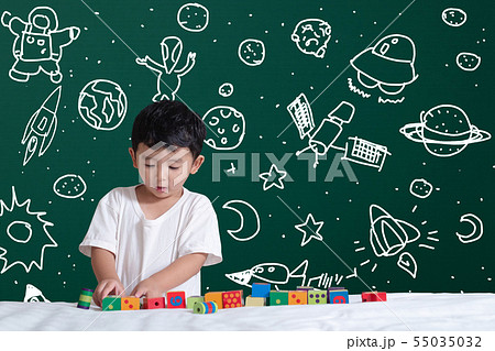 Asian kid learning by playing with his imagination Asian kid learning by playing with his imagination 55035032