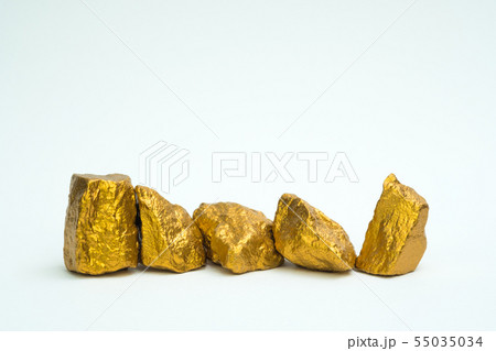 A pile of gold nuggets or gold ore on white A pile of gold nuggets or gold ore on white 55035034