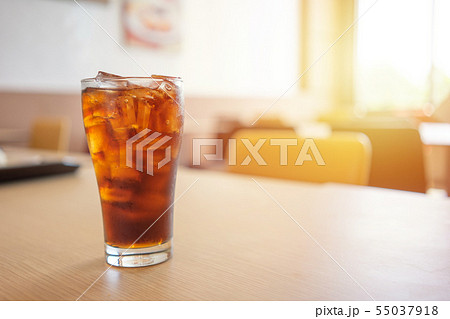Glass of soft drinks placed on the table gives a 55037918