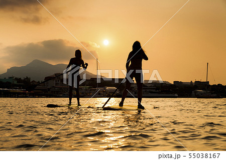 Silhouette of a beautiful woman on Stand Up Paddle Board. SUP Silhouette of a beautiful woman on Stand Up Paddle Board. SUP 55038167