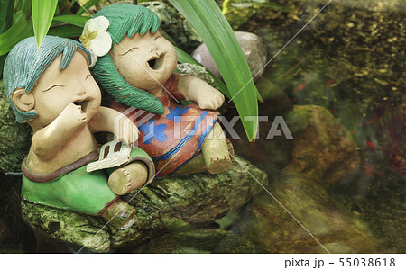 Smiling Boy and Girls Doll Sitting in Garden. 55038618