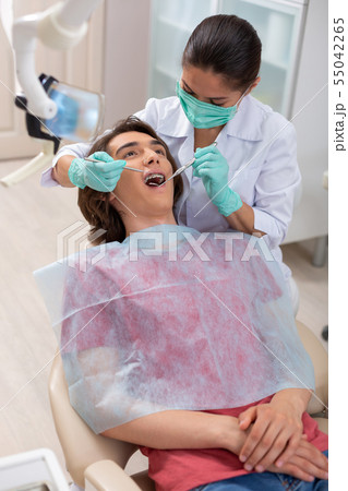 Doctor wearing green gloves and a green mask 55042265