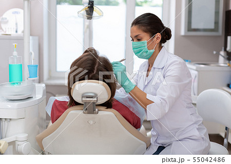 Young male patient sitting in a dental chair Young male patient sitting in a dental chair 55042486