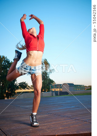 Athlete celebrating jumping and leaping against a Athlete celebrating jumping and leaping against a 55042566
