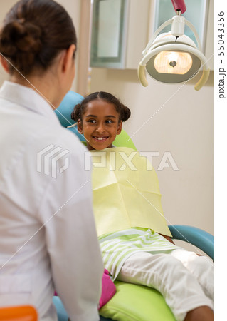 Woman doctor talking to a young female patient 55043356