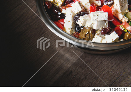Close-up of delicious gourmet tomato and olives feta cheese salad sprinkled with spices of herbs 55046132