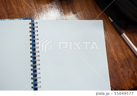 Blank notebook pages and pens on the desk. 55049577