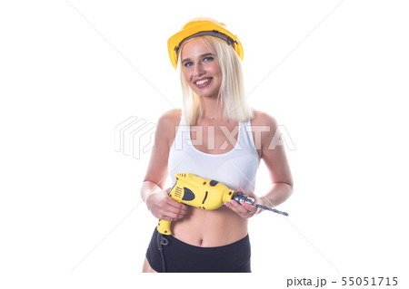 Young sexy woman in construction helmet holding a drill isolated on white background. Woman builder. Young sexy woman in construction helmet holding a drill isolated on white background. Woman builder. 55051715
