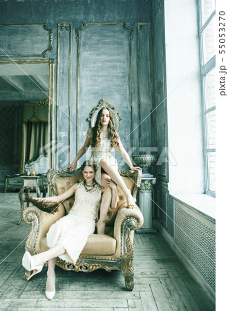two pretty twin sister blond curly hairstyle girl in luxury house interior together, rich young 55053270