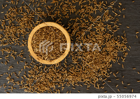 Dry caraway fruit on grey stone Dry caraway fruit on grey stone 55056974