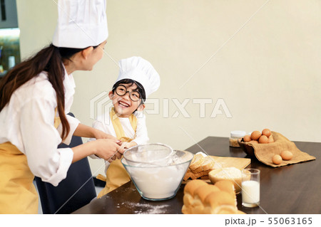 Happy asian family in the kitchen.Mother and son h Happy asian family in the kitchen.Mother and son h 55063165
