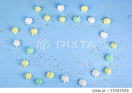 Meringue on a blue wooden background Meringue on a blue wooden background 55065009