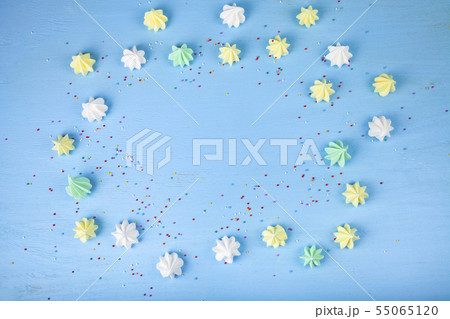 Meringue on a blue wooden background Meringue on a blue wooden background 55065120