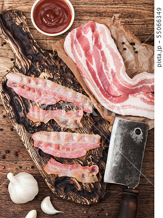 Grilled bacon strips on vintage wooden board Grilled bacon strips on vintage wooden board 55066349