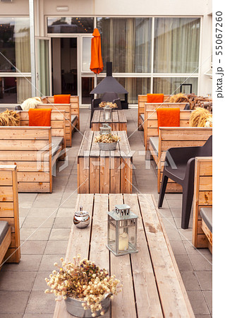Outdoor restaurant terrace with wooden furniture Outdoor restaurant terrace with wooden furniture 55067260