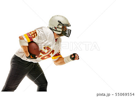 American football player posing with ball on black background. Super Bowl concept. Concept American 55069554