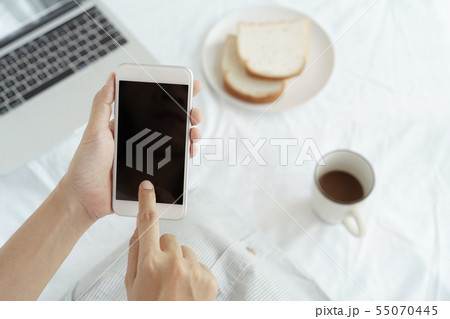 Hands of working woman holding and using phone 55070445