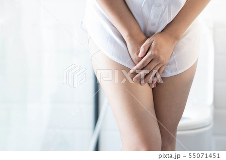 Close up woman stomachache with toilet in the Close up woman stomachache with toilet in the 55071451
