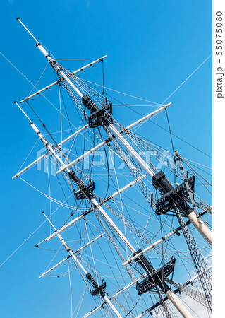 the mast of a sailboat against a blue sky the mast of a sailboat against a blue sky 55075080