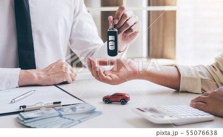 Car rent agent manager holding key of new car 55076638