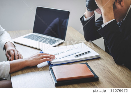 Stressed businessman receive fired letter from Stressed businessman receive fired letter from 55076675