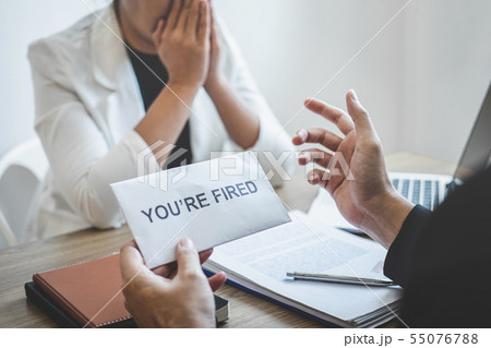 Stressed business woman receive fired letter from Stressed business woman receive fired letter from 55076788