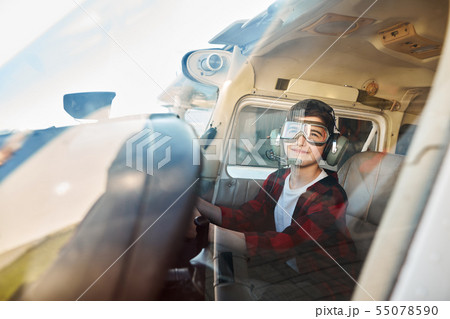 kid sitting in small aircraft cabin, playing with control wheel kid sitting in small aircraft cabin, playing with control wheel 55078590