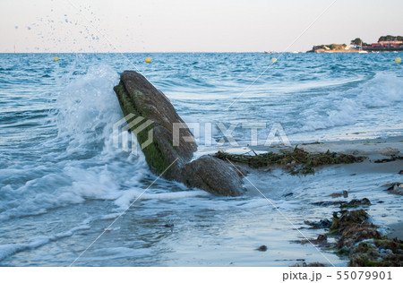 Closeup of wave on rocks in border ocean  55079901