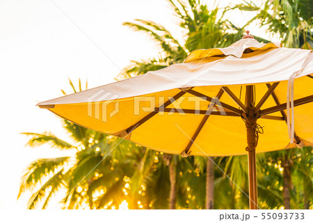 Umbrella and chair on the beautiful beach and sea at sunrise time for travel and vacation Umbrella and chair on the beautiful beach and sea at sunrise time for travel and vacation 55093733