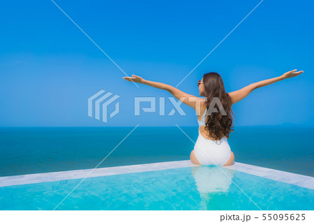 Portrait beautiful young asian woman happy smile relax in swimming pool for travel vacation 55095625